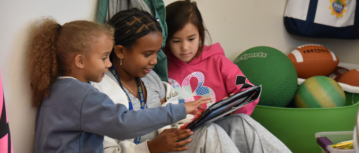 Middle School Students Read to First Graders - Seven Hills School
